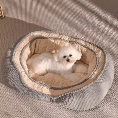 Luxurious pet bed with plush interior, suitable for small dogs, placed on a textured surface, showcasing comfort and style for pet owners seeking high-quality pet accessories.