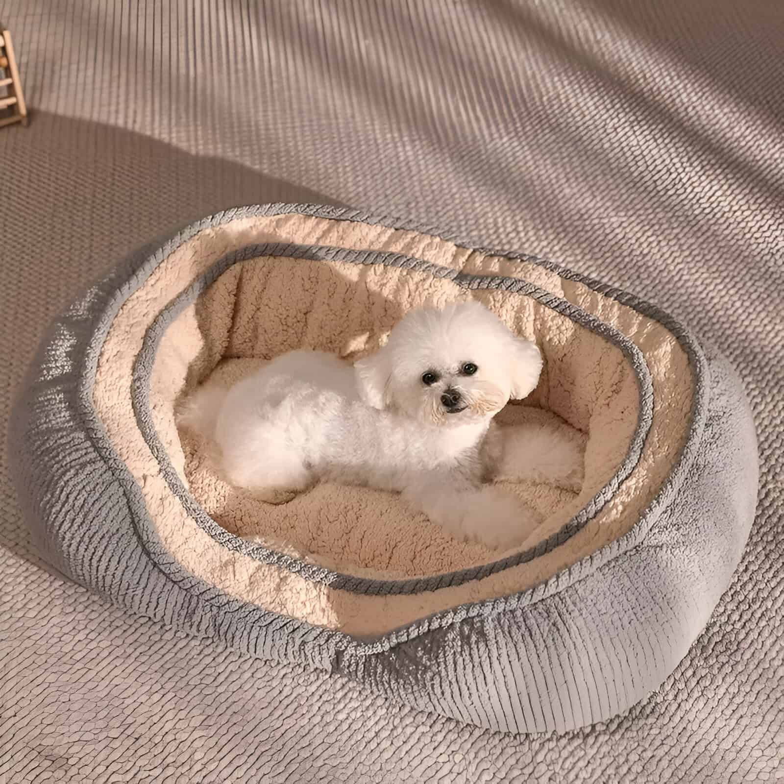 Luxurious pet bed with plush interior, suitable for small dogs, placed on a textured surface, showcasing comfort and style for pet owners seeking high-quality pet accessories.