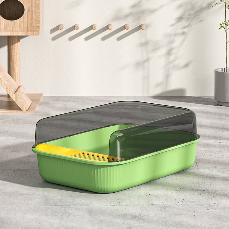 Cat litter box with a green base, dark lid, and yellow vent, designed for pet owner convenience and hygiene.