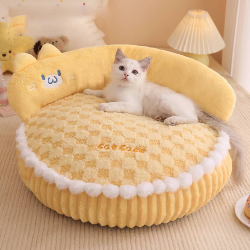 Fluffy yellow cat bed shaped like a croissant with a cute cat lounging inside, cozy and stylish pet furniture, perfect for small cats and kittens, best for everyday comfort and decor.