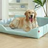 Golden retriever lying in a light blue pet bed indoors, smiling and happy, cozy and comfortable pet lounge for dogs and cats, Monalisa Store pet accessories, pet care products, and dog beds for comfort and relaxation.