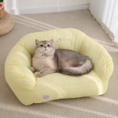 Fluffy gray cat lying on a yellow pet bed with floral embroidery, comfortable and stylish pet furniture for cats, cozy home pet accessory, Monalisa Store.