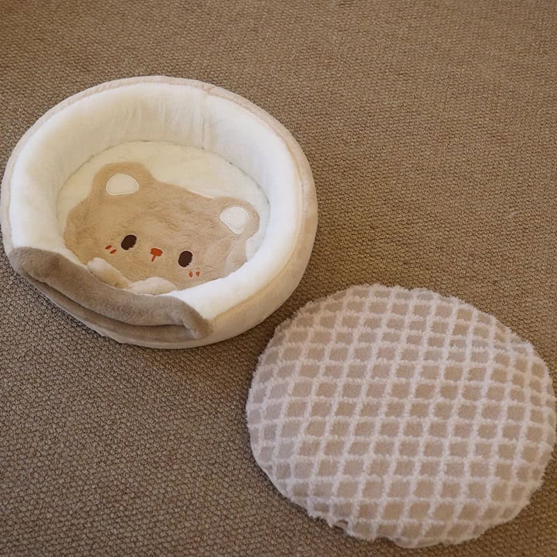 Plush bear-shaped cat bed with removable fleece cushion for pet comfort and cozy resting space.