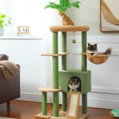 Cat tree and play tower with multiple perches, cozy cubby, and hanging basket, perfect for cats to climb, scratch, and relax in a stylish living room. Features green and beige scratch posts, designed for feline fun.