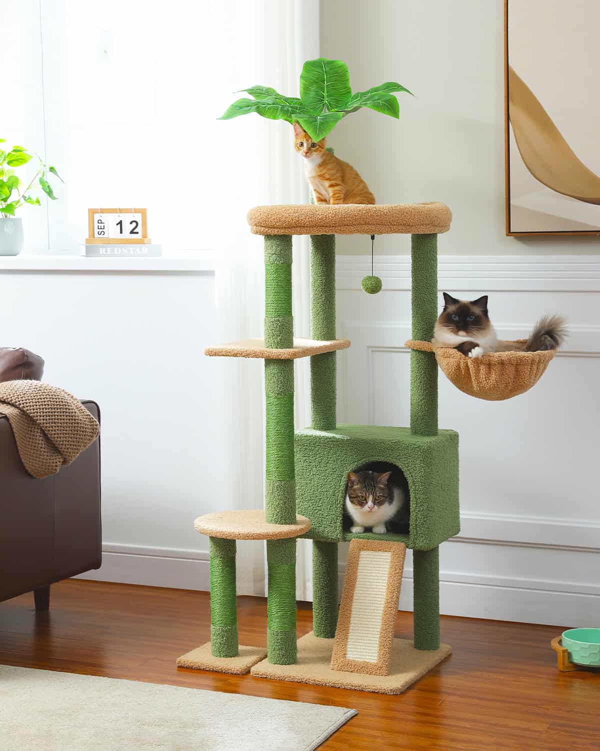 Cat tree and play tower with multiple perches, cozy cubby, and hanging basket, perfect for cats to climb, scratch, and relax in a stylish living room. Features green and beige scratch posts, designed for feline fun.
