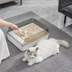 Litter box with a cat laying next to it, modern pet hygiene, Monalisa Medical store pet care essentials, clean and stylish cat litter box for odor control and comfort, pet grooming and health products available.