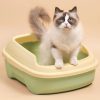 Cat using a litter box, close-up of a fluffy cat with blue eyes standing in a beige and green litter box, domestic cat care, clean and comfortable cat toilet, Monalisa Store pet supplies.