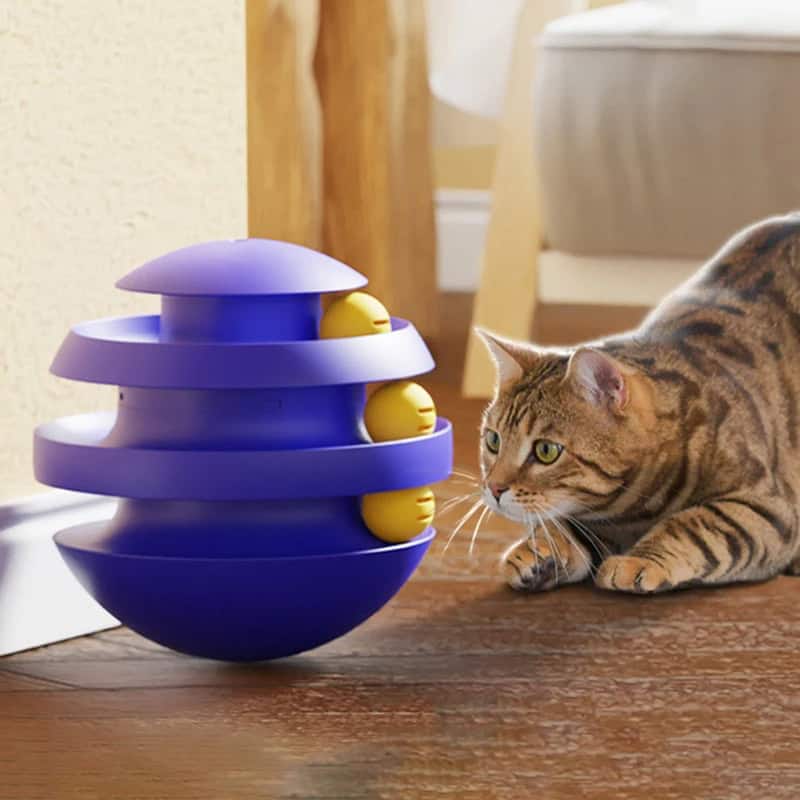 Ball interactive toy for cats on wooden floor with curious Bengal cat.