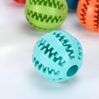 Rubber dog toy ball with textured spikes in blue, designed for chewing and dental health; colorful, durable pet toy for dogs from Monalisa Store.
