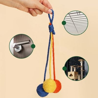 Colorful wool balls hanging door lock, grill cover, and cat tree in background, inside Monalisa Store, promoting home decor and pet furniture for modern interior design.