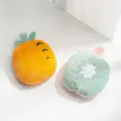 Pineapple-shaped plush pillow with a cute facial expression, vibrant yellow and green colors, ideal for nursery decor or children's room accessories.