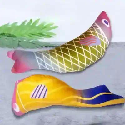 Fish-shaped decorative pillow with colorful abstract patterns for home decor.