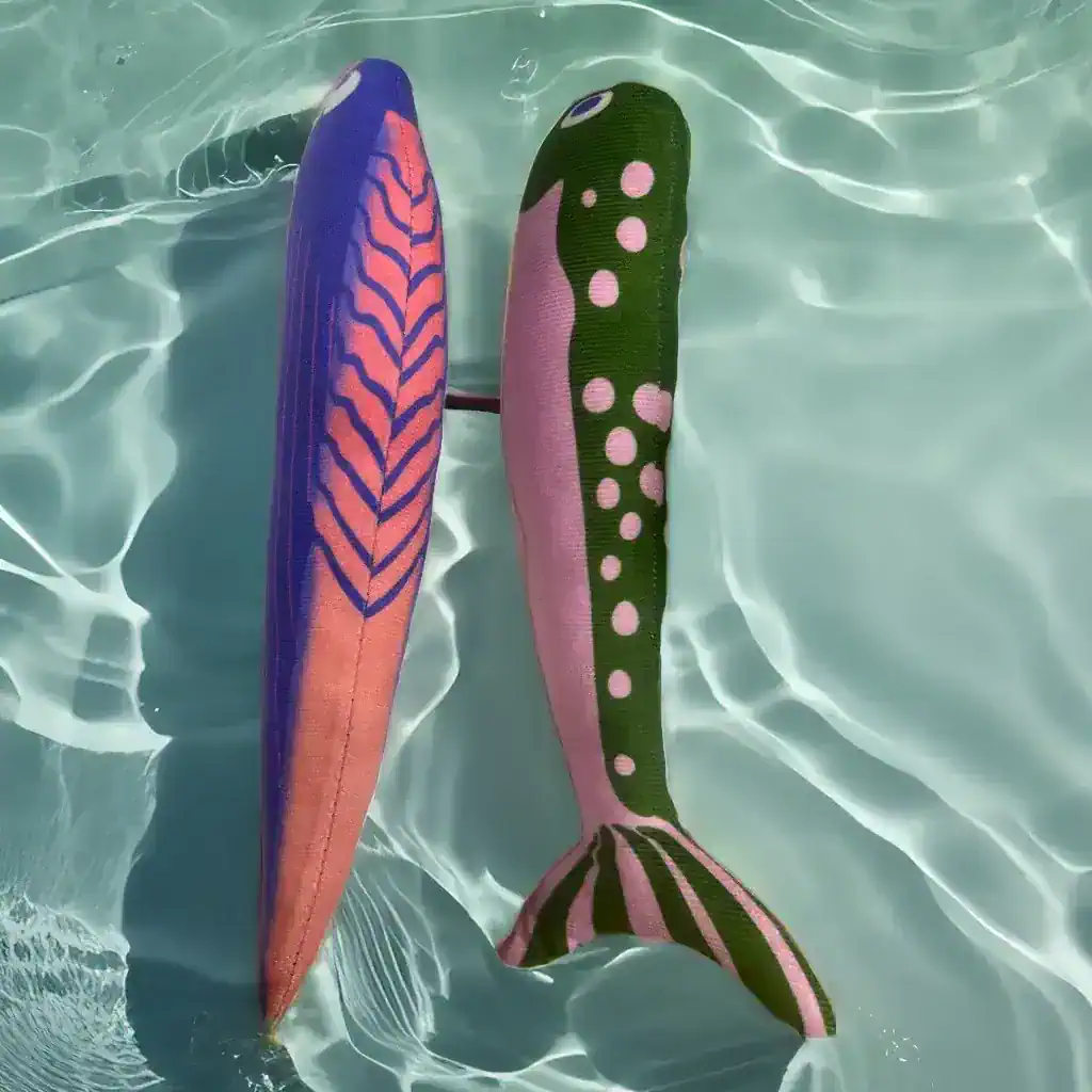 Vibrant pair of colorful sock fins resembling fish fins floating in clear pool water, perfect for aquatic activities and swim training, showcasing fun and functional pool accessories.