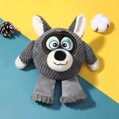 Plush dog toy with a doppelgänger mask, grey and white, on colorful background for kids and pet lovers.