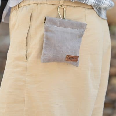 Coin purse with a carabiner clip, designed for convenience and style, featuring a small zipper compartment and a neutral fabric finish, perfect for carrying essentials on the go.