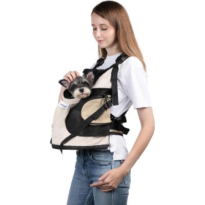 Dog carrier backpack in beige and black, ideal for travel and outdoor activities, featuring comfortable straps and secure enclosure. Perfect for pet owners on the go.