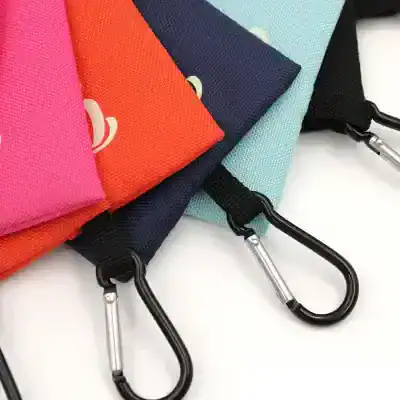 Colorful fabric pouches with metal carabiner clips, ideal for accessories, keys, or small essentials, perfect for travel or daily use.