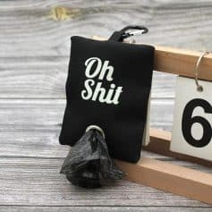 Oh Shit humorous keychain with black fabric, metal ring, and attached black plastic bag, perfect as a quirky accessory for bags or keys. Unique and funny gift idea for friends with a sense of humor.