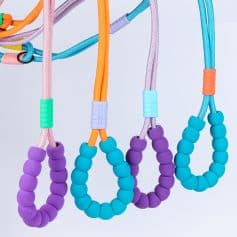 Colorful silicone beaded baby teething rings with adjustable cords for infant comfort and dental health. Perfect for soothing teething pain and promoting oral development. Safe, durable, and adorable baby accessories.