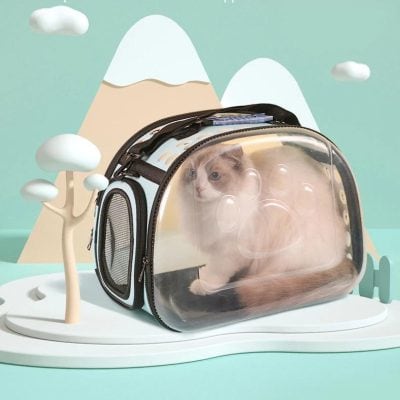 Portable cat carrier with transparent front window, perfect for travel and vet visits, featuring comfortable space for pets and easy-to-carry design.