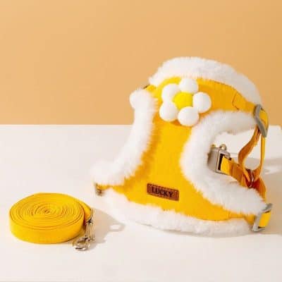 Yellow pet harness with fluffy white trim and flower embellishment, adjustable with metal buckle, and matching yellow leash, ideal for small dogs or cats at Monalisa Store for pet safety and comfort.
