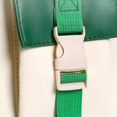 Heavy-duty green strap with white buckle for medical or optometric equipment, designed for secure fastening and support. Durable strap used in optometry clinics, eye care, or medical practice furniture.