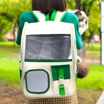 Dog carrier backpack with pet air holes, worn by a woman on a park walk, ideal for transporting small animals comfortably and securely.