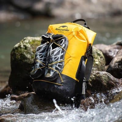 Yellow Naturehike dry bag with hiking shoes attached, suitable for outdoor adventures and water sports; waterproof gear for camping and trekking.