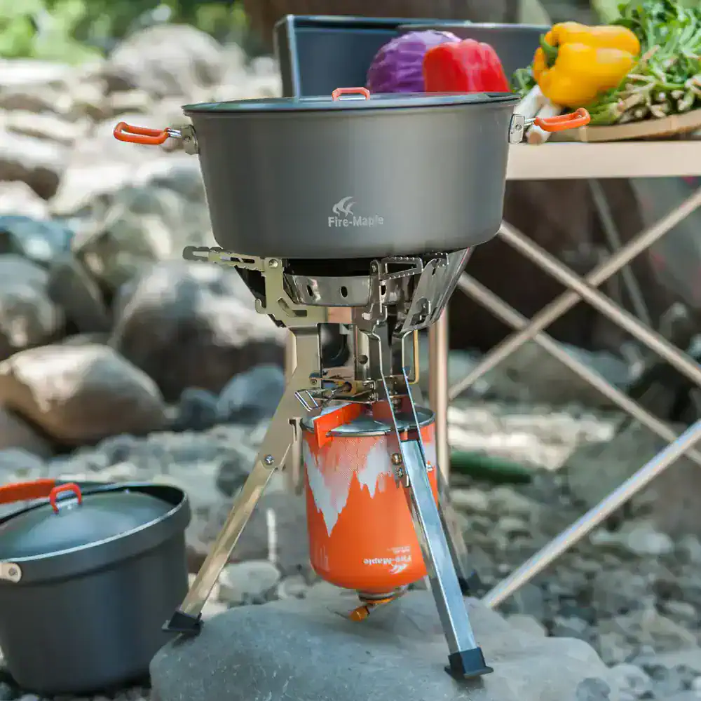 Camping portable stove with cooking pan, perfect for outdoor camping, hiking, and picnics, featuring durable construction and easy setup for delicious meals in nature.