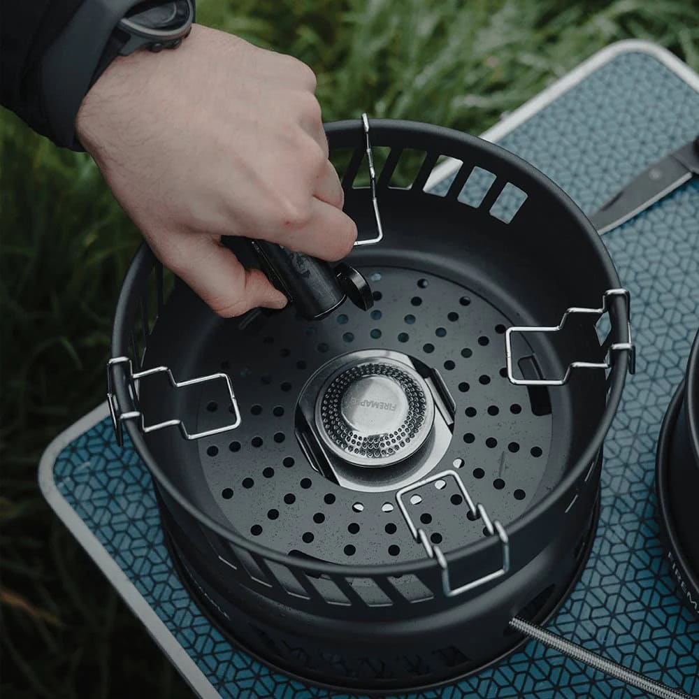 Portable outdoor camping stove with propane canister and ignition system for cooking in nature. Perfect for camping, hiking, and outdoor adventures, providing reliable heat source in the wilderness.