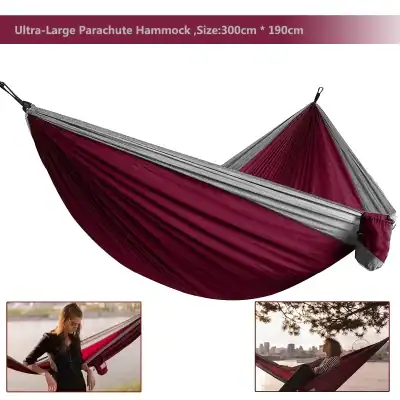 Lightweight red and gray outdoor parachute hammock, 300cm x 190cm, ideal for camping and relaxation; quick setup and durable material.