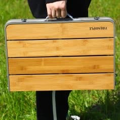 Lightweight portable folding table with bamboo surface, ideal for outdoor activities, picnics, and travel, featuring sturdy aluminum frame for durability and convenience.