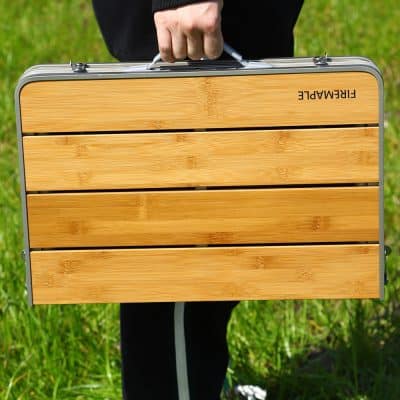 Lightweight portable folding table with bamboo surface, ideal for outdoor activities, picnics, and travel, featuring sturdy aluminum frame for durability and convenience.