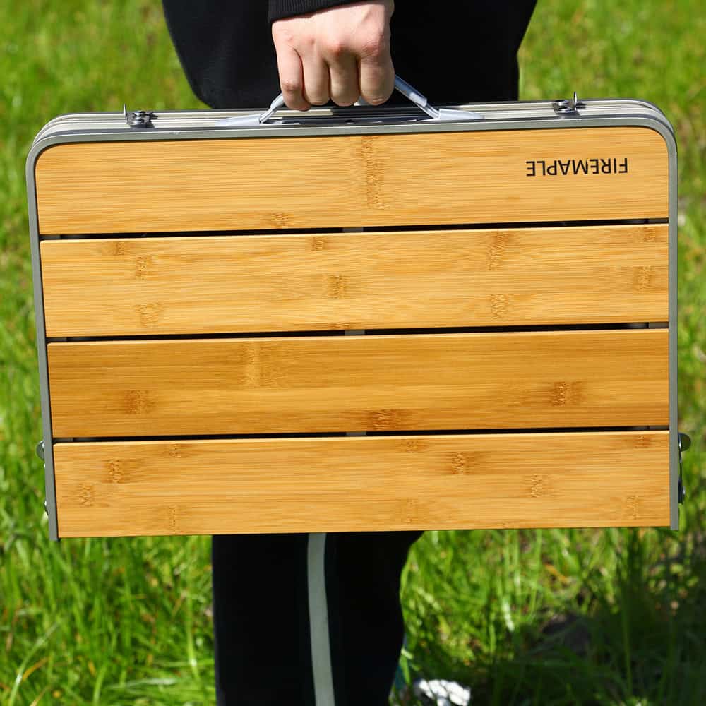 Lightweight portable folding table with bamboo surface, ideal for outdoor activities, picnics, and travel, featuring sturdy aluminum frame for durability and convenience.