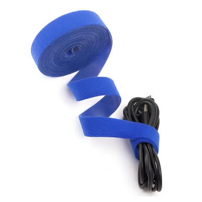 Blue silicone cable organizer with Velcro strap for medical and optical equipment.