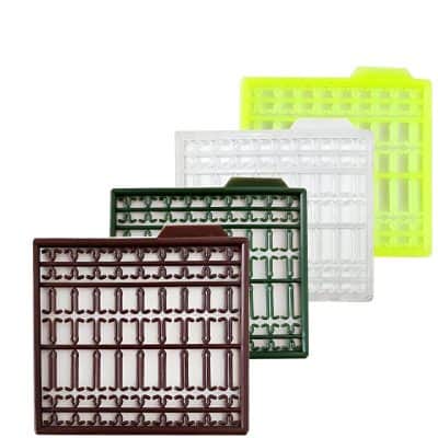 Flexible silicone eyelash extension trays for professional use, available in assorted colors including brown, green, white, and yellow, designed to organize lash extensions efficiently.
