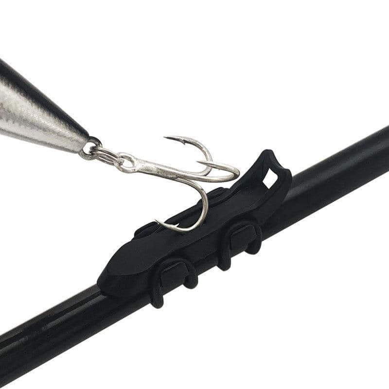 Metal fishing lure with treble hook mounted on a black optical instrument clip, used in fishing accessories and optometric gear images.