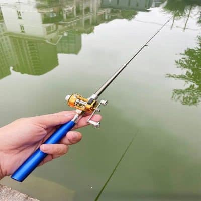 Fishing rod by a pond with city buildings reflection, high-quality fishing equipment, recreational fishing gear for outdoor sports and angling, Monalisa Store.