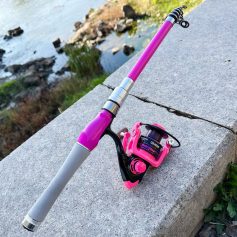 Fishing rod and reel on a concrete ledge by water, outdoor fishing gear.