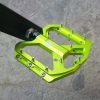 Aluminum mountain bike pedal with vibrant green finish and durable construction, designed for optimal performance and traction in cycling adventures.
