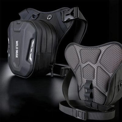 Black motorcycle backpack with reinforced shoulder straps and a gray protective back pad, designed for rider safety and storage, showcased against a dark background.