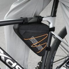 Sturdy black and orange cycling saddlebag attached to a modern bicycle frame, perfect for bike touring and essentials storage during outdoor adventures.