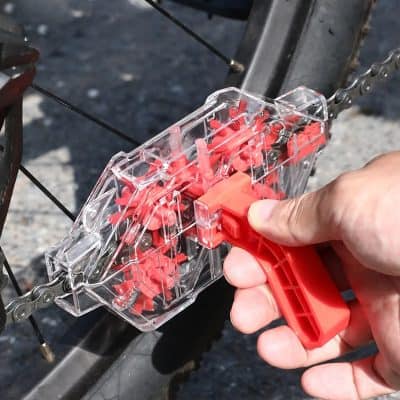 Plastic bike chain tool used for chain maintenance and repair at Monalisa Medical store, ideal for cyclists needing professional chain cleaning and fixing solutions.