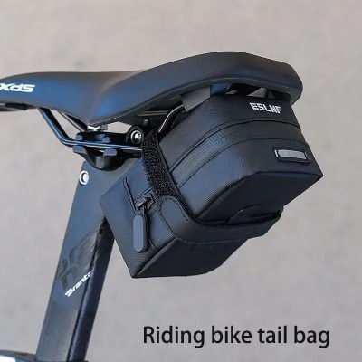 Durable black riding bike tail bag attached to bicycle saddle, perfect for cycling accessories and essentials. Enhanced visibility with reflective strip for safe riding.