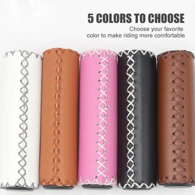 White, tan, pink, black, and brown bicycle handlebar grips with decorative stitching for comfortable riding.