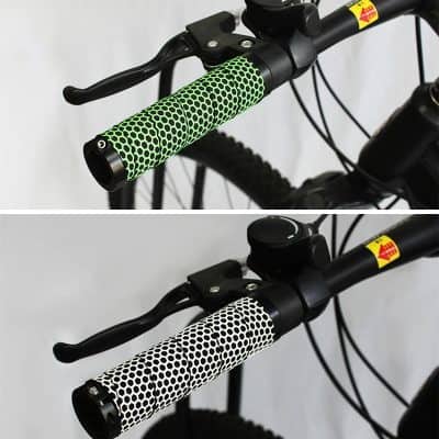 Bright green and black ergonomic bicycle handlebar grip with honeycomb pattern, designed for comfort and style in cycling.