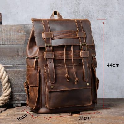 Rich brown leather backpack with multiple pockets, adjustable straps, and vintage style, perfect for fashion-forward and practical daily use.
