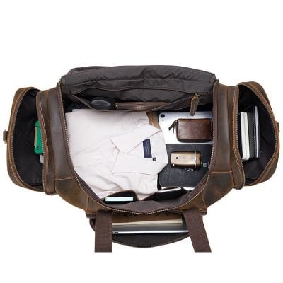 Organized travel bag with clothing, gadgets, wallet, and accessories, perfect for business trips and vacations. High-quality leather design for stylish and functional travel essentials.