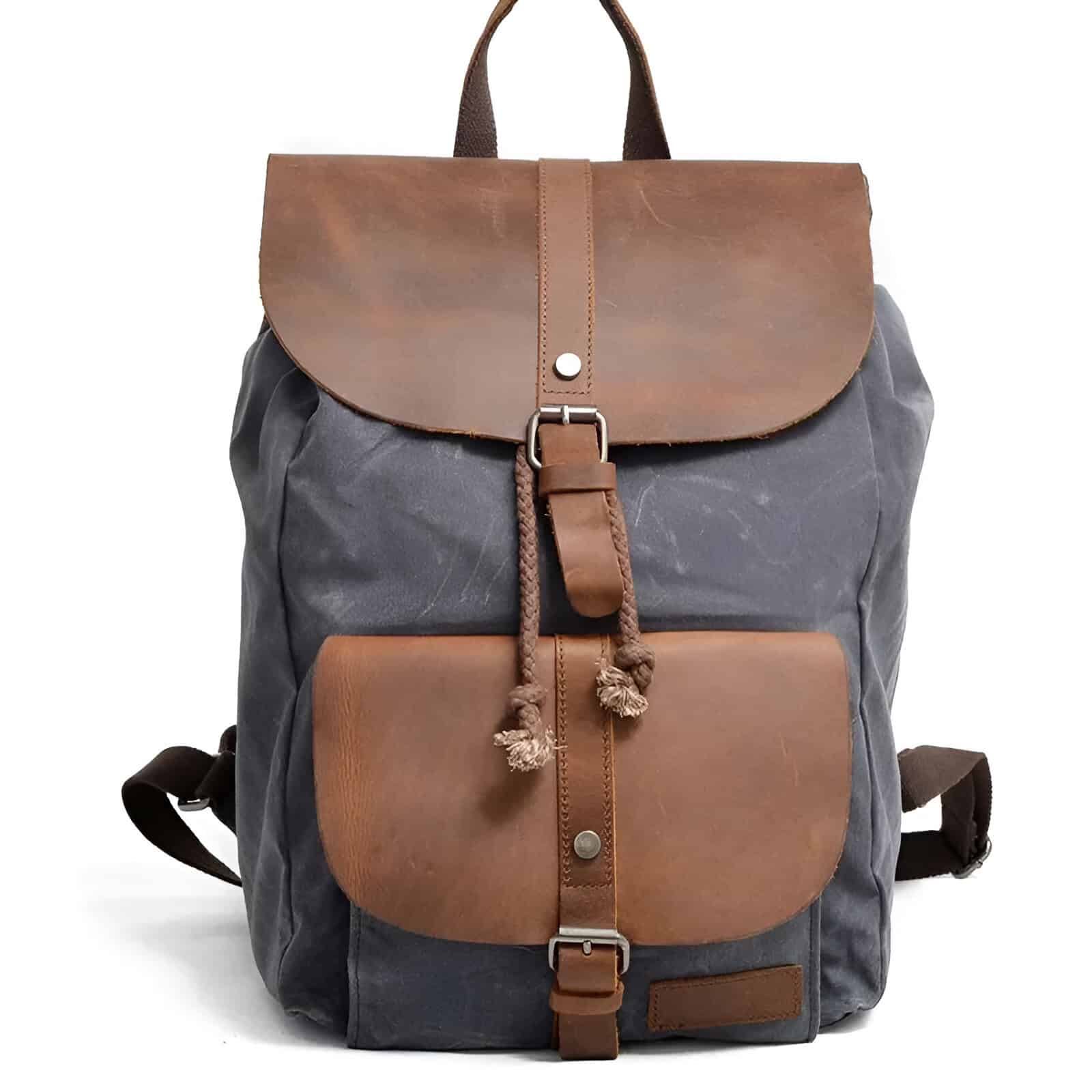 Stylish canvas and leather backpack with multiple compartments, perfect for travel, daily use, and outdoor activities. Durable design combines comfort and fashion.