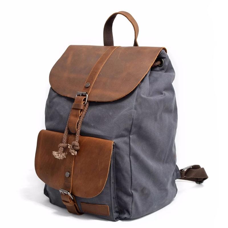 Backpack with brown leather accents and adjustable straps, ideal for daily use or travel. High-quality, stylish, and durable design perfect for carrying essentials comfortably.